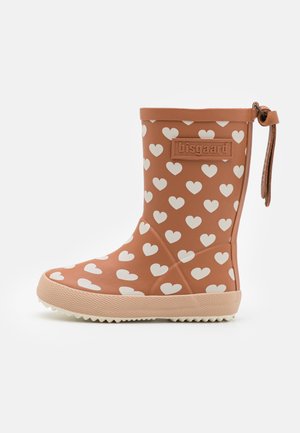 Brown rubber rain boot featuring white heart patterns, textured sole, and a pull tab with a leather accent. Bisgaard logo on the side.