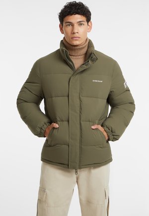 Olive green puffer jacket with a high collar, zip closure, and elastic cuffs, featuring stitched panels and logo detail on the chest.