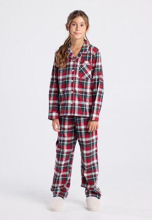 Ensemble de pyjama à carreaux rouges et verts comprenant une chemise boutonnée avec une poche poitrine et un pantalon assorti, fabriqué dans un tissu doux. Chaussons moelleux blancs.