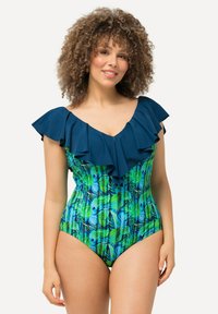 Maillot de bain une pièce avec un décolleté à volants navy, un motif de feuilles tropicales vertes et bleues éclatantes, et une silhouette ajustée.