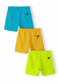 Trois paires de shorts dans des couleurs vives : bleu, jaune et vert fluo. Chacun est doté d'une taille élastique et d'une poche arrière.