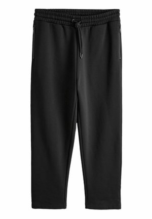 Sorte sweatpants med tilspidset pasform, elastisk taljebånd, snøre og lynlåslommer i siden, vist fladt mod hvid baggrund.