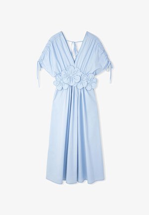 Light blue dress with short puff sleeves, V-neck, and floral fabric appliqué at the waist. Made from a soft, flowing material.