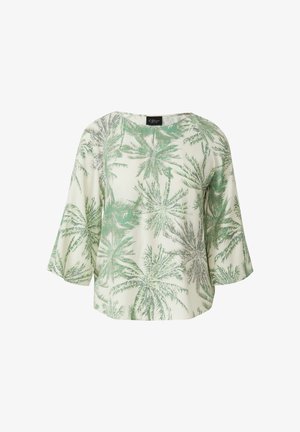 Blouse blanche avec motifs de feuilles de palmier vert clair et gris, manches larges trois-quarts et col rond.