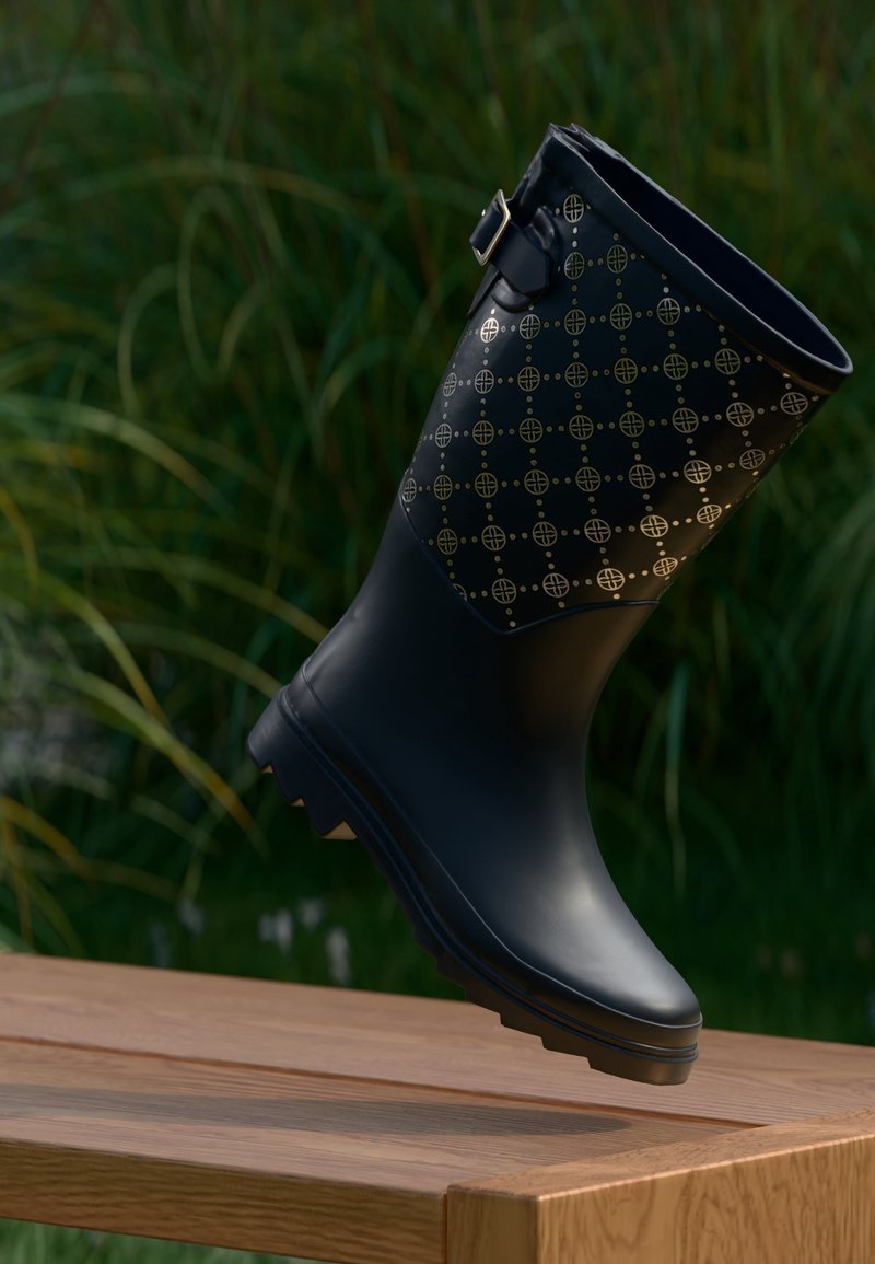 Botte de pluie en caoutchouc noir avec un motif doré, équipée d'une boucle latérale et d'une semelle texturée antidérapante.