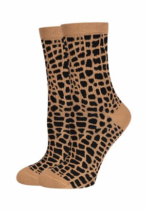 Calzini beige con un motivo a stampa leopardata nera, dotati di polsini a coste e una texture liscia. Lunghezza standard a crew, adatti per l'uso quotidiano.