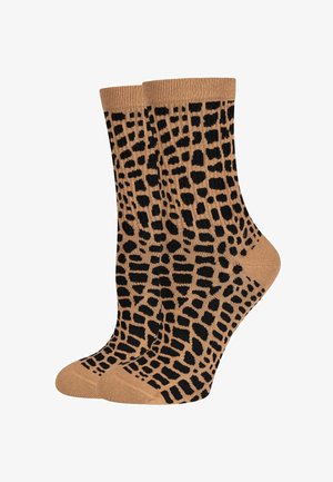 Calzini beige con un motivo a stampa leopardata nera, dotati di polsini a coste e una texture liscia. Lunghezza standard a crew, adatti per l'uso quotidiano.