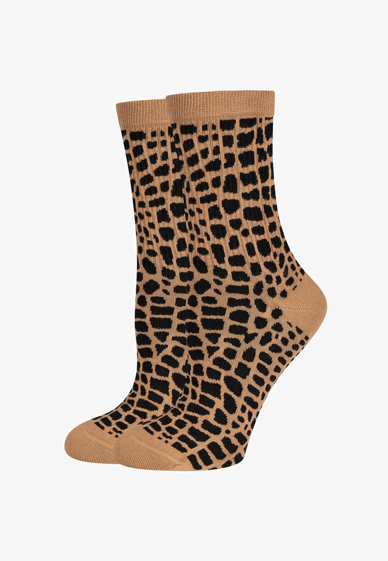 Calzini beige con un motivo a stampa leopardata nera, dotati di polsini a coste e una texture liscia. Lunghezza standard a crew, adatti per l'uso quotidiano.