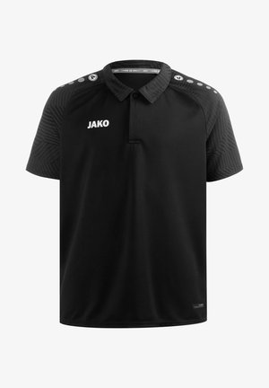 Zwarte poloshirt met kraag, met textuur op de zwarte mouwen en een wit logo "JAKO" op de borst. Eenvoudig, strak ontwerp met korte mouwen.