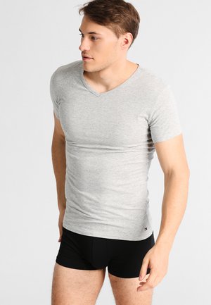 Grey cotton short-sleeve V-neck t-shirt with a fitted design. Features a small logo detail on the bottom left hem.