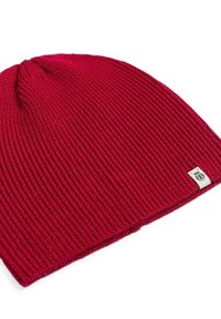 Red knit beanie made of ribbed fabric, featuring a sewn logo tag. The design is tapered at the top, with a textured finish throughout.