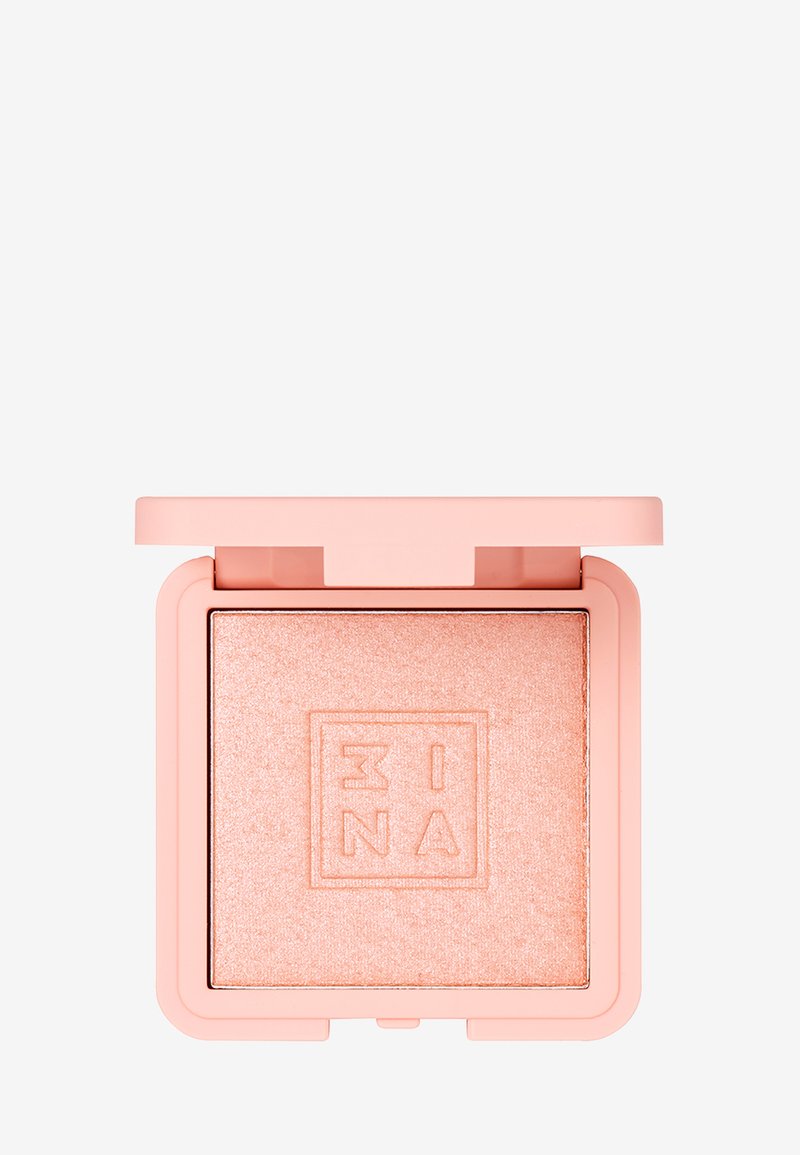 Rougecompact med en myk rosa matte overflate, med en firkantet form. Inni er det et glitrende ferskenpudder med et hevet logo-design.