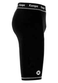 Schwarze Sportshorts aus dehnbarem Material, ausgestattet mit einem strukturierten Bund, der das "Kempa"-Logo und silberne Akzentnähte aufweist.
