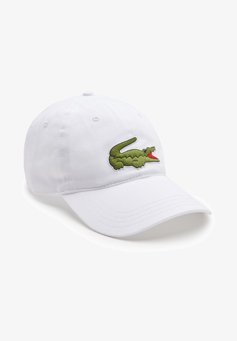 Fehér, pamutból készült baseball sapka, amelyen zöld hímzett krokodil logo található az elején. Puha tapintású, ívelt karimájú dizájn.