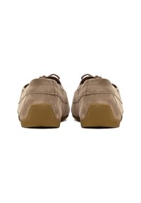 Beige ruskind slip-on sko med en fleksibel brun gummisål, der har en syet detalje bagpå og snørebånd for justering.