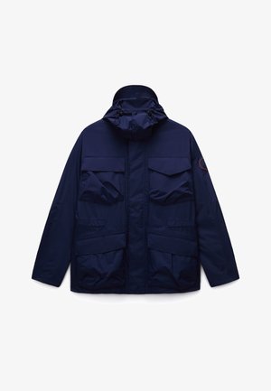 Navy blue waterproof jacket with a hood, multiple front pockets, and a zip closure. Features a textured fabric for durability.