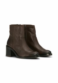 Brown leather ankle boots with a smooth texture, side zippers, and a block heel. The design features subtle stitching along the edges.