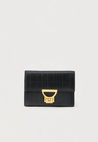 Black leather wallet with horizontal stitching and a gold-tone geometric clasp on a light background.