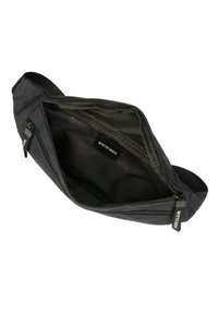 Sac à taille en tissu noir avec deux compartiments zippés. Présente une texture lisse et une étiquette intérieure. Sangle ajustable incluse.