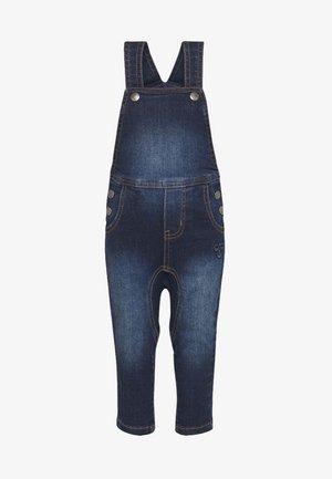 Spijkerbroek tuinbroek met verstelbare bandjes, knoopsluitingen, voorzakken en een vervaagde donkerblauwe wassing. Voorzien van geborduurd logo aan de voorkant.