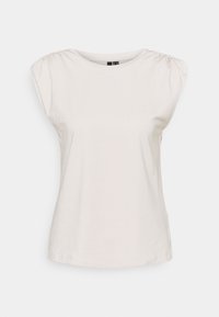 Ljust beige t-shirt med korta puffärmar, rund halsringning och mjukt bomullsmaterial. Har insamlad detalj vid axelsömmarna.