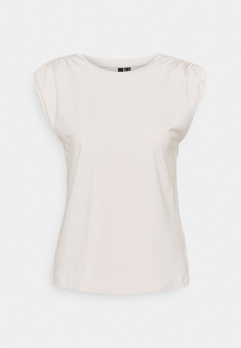 T-shirt beige clair avec des manches courtes bouffantes, un col rond et en coton doux. Présente des détails froncés au niveau des coutures des épaules.