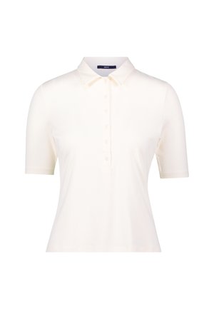 Polo shirt beige clair en tissu lisse, avec un col classique, des manches courtes et une patte de boutonnage à cinq boutons. Pas de motifs visibles.