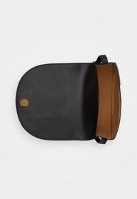 Black leather shoulder bag with a rounded flap, tan interior, and a gold-colored snap closure. Visible stitching on the side.