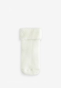 Vit fluffig strumpa med en mjuk, plyschig resårkanten upptill och en texturerad kropp. Designen är enkel och utan prydnader, med fokus på komfort.