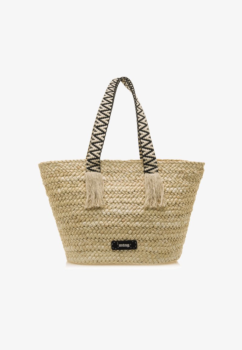 Bolso de tote de paja trenzada en color beige natural con asas de patrón en negro y blanco y acentos de borlas. Presenta un pequeño parche de logo negro en la parte frontal.