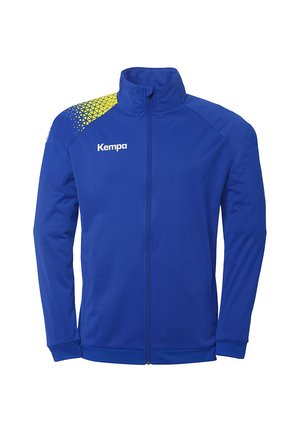 Blå sportsjakke lavet af glat stof med høj krave. Har et gult geometrisk mønster på skulderen og "Kempa" logo på brystet.