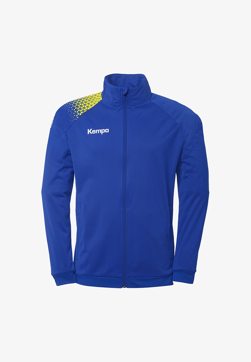 Blå sportsjakke lavet af glat stof med høj krave. Har et gult geometrisk mønster på skulderen og "Kempa" logo på brystet.