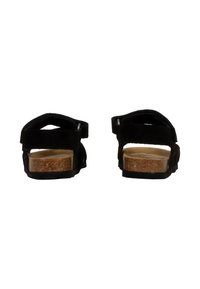 Sandales en daim noir avec des bandes Velcro, semelle intérieure en liège, semelle en caoutchouc texturé et design à dos ouvert. Style simple et fonctionnel.