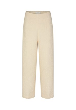 Cream-colored cropped pants made of textured fabric with subtle patterns. Features a high waist and a straight-leg silhouette.