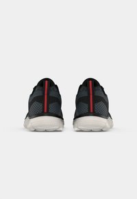 Black and gray athletic shoes with a breathable mesh upper, featuring a red accent stripe and a white outsole with textured grip pattern.