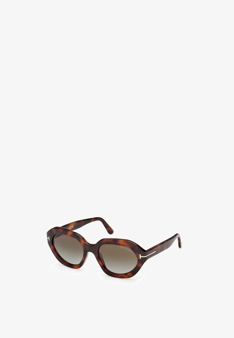 Occhiali da sole geometrici oversize a tartaruga con lenti scure sfumate e sottili aste con dettaglio metallico a forma di "T".