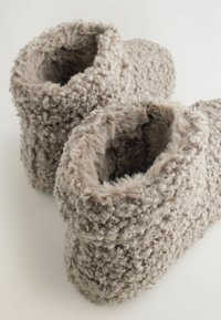Grå, teksturerede stoffsandaler med en fluffy, løkkeret overflade og åbne tops. Blød indre foring giver komfort og varme.