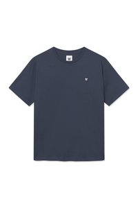 Navy blue T-shirt made of cotton with a crew neck, short sleeves, and a small logo patch on the left chest. Smooth fabric texture.