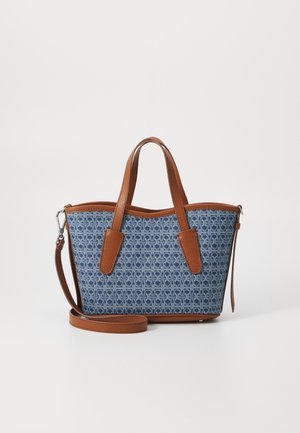 Blue patterned fabric bag with tan leather accents, dual handles, and detachable strap. Features a structured shape and textured surfaces.