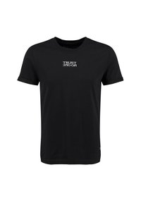 Camiseta de manga corta negra hecha de algodón, con el texto blanco "NO CONFÍES EN NADIE" impreso al revés en el centro del frente.