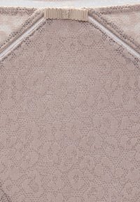 Beige lace fabric with a floral pattern, featuring a smooth texture and a seam at the top with a small elastic loop.