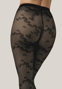 Collant neri a fantasia con una texture trasparente, caratterizzati da un motivo floreale in una tonalità più scura e una vita solida.