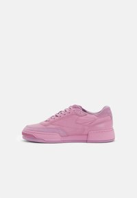 Pink athletic sneaker with a smooth leather upper, textured accents, and a robust sole. Features flat laces and padded collar for comfort.