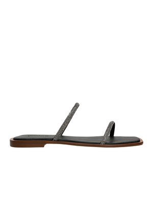 Black leather flat sandals with thin straps featuring decorative metallic accents, and a textured footbed; minimalist design with a flat sole.