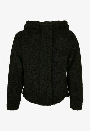 Zwarte capuchonjack gemaakt van textuurrijke, pluizige stof. Beschikt over een ronde onderkant en lange mouwen. Geen zichtbare sluitingen of patronen.