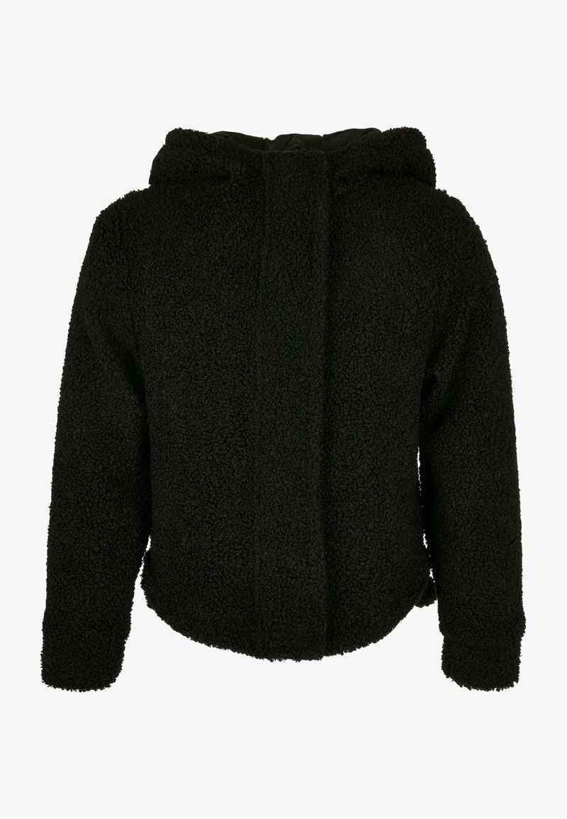 Must tumesjak, mis on valmistatud tekstuurist, pehmest kangast. Omab ümarat krae ja pikki varrukaid. Ilma nähtavate kinnituste või mustriteta.