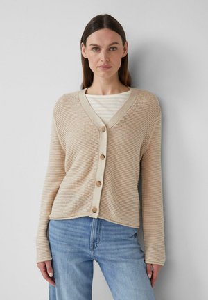 Beige gebreide cardigan met een V-hals, voorzien van vijf knopen, ribgebreide randen en lange mouwen, gedragen over een gestreepte lichtgekleurde top.