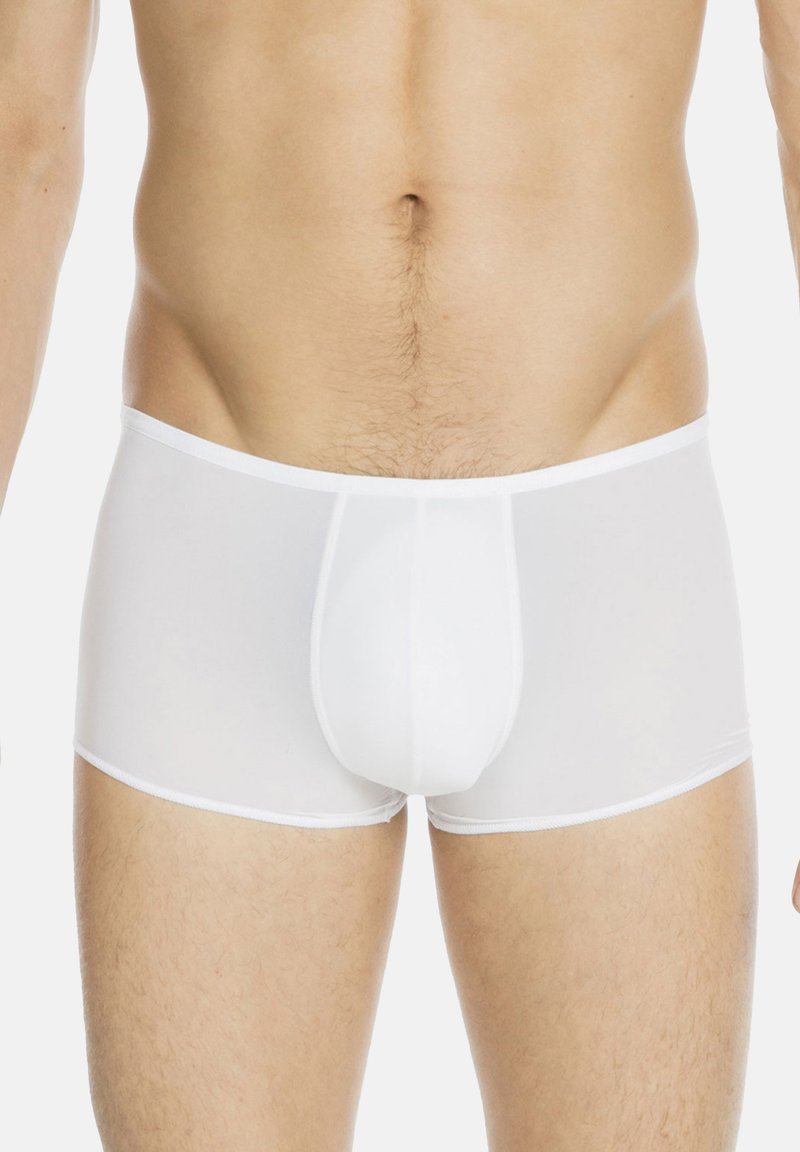 Boxer da uomo bianchi realizzati in tessuto trasparente. Presentano un design aderente, una vita elasticizzata e una cucitura centrale per dare struttura.
