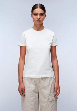 Witte katoenen T-shirt met korte mouwen, ronde hals en een discreet logo in lichtgrijze details op de borst. Gemaakt met beige cargobroeken.