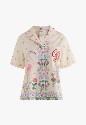 Chemise courte crème à boutons avec flamant rose, fleurs colorées et texte rouge "Cath Kidston" sur la poche avant.